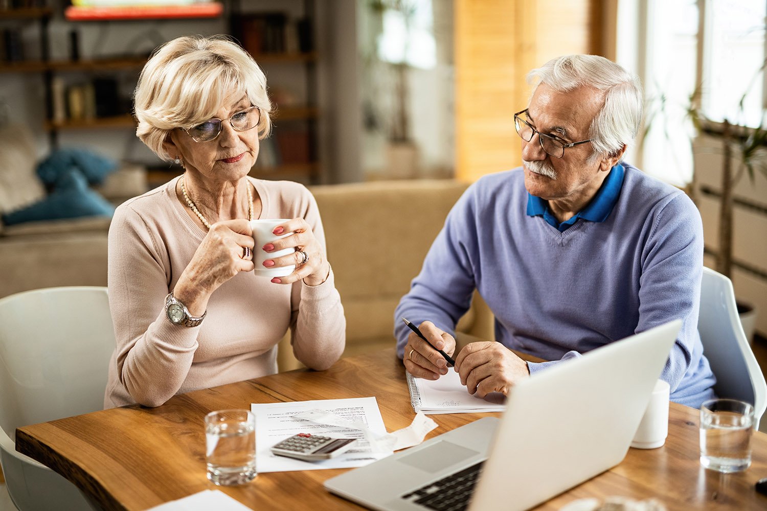 Couple reviewing estate planning documents at home